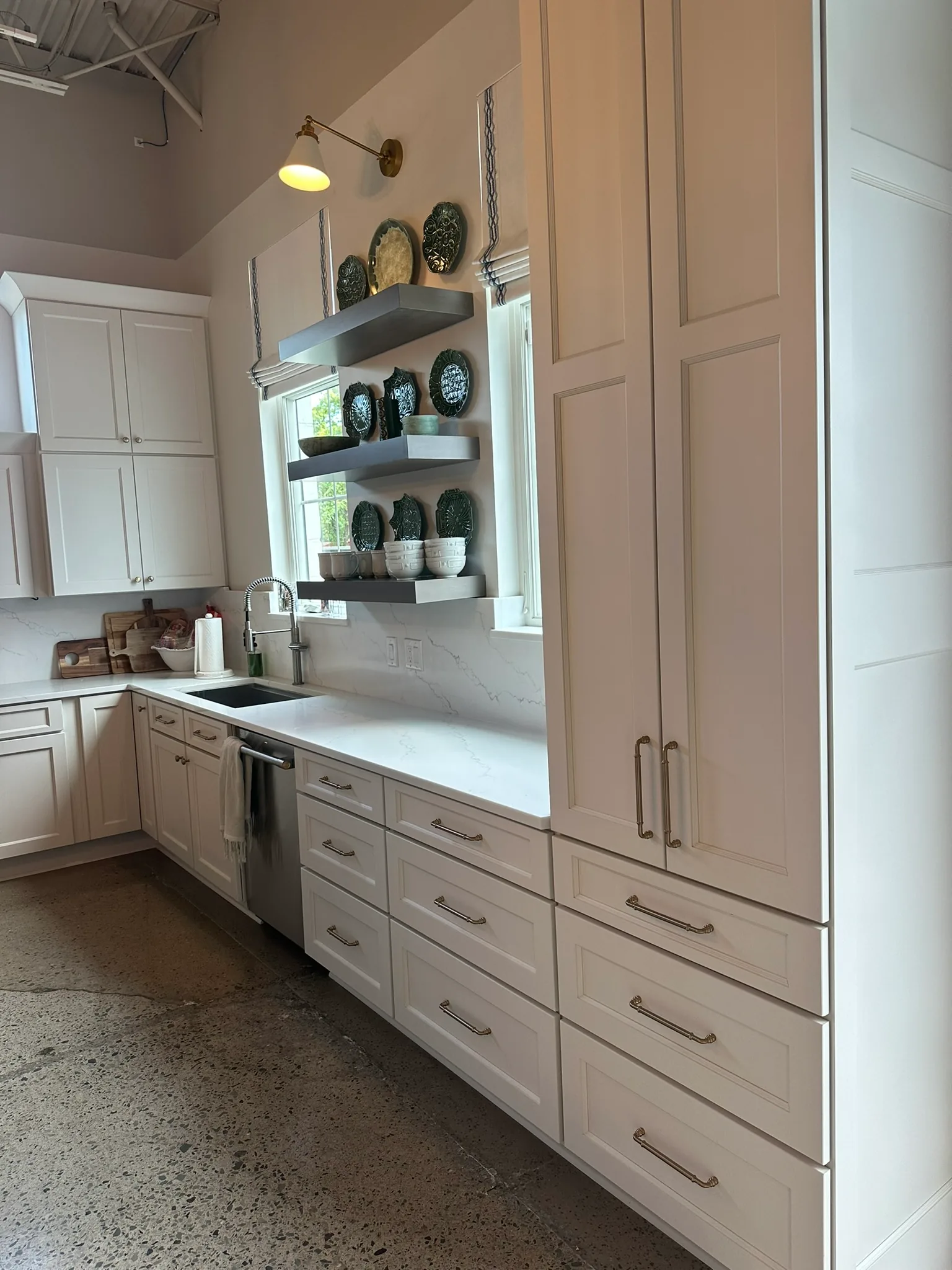 Cream kitchen with floating wood shelves and quartz counters